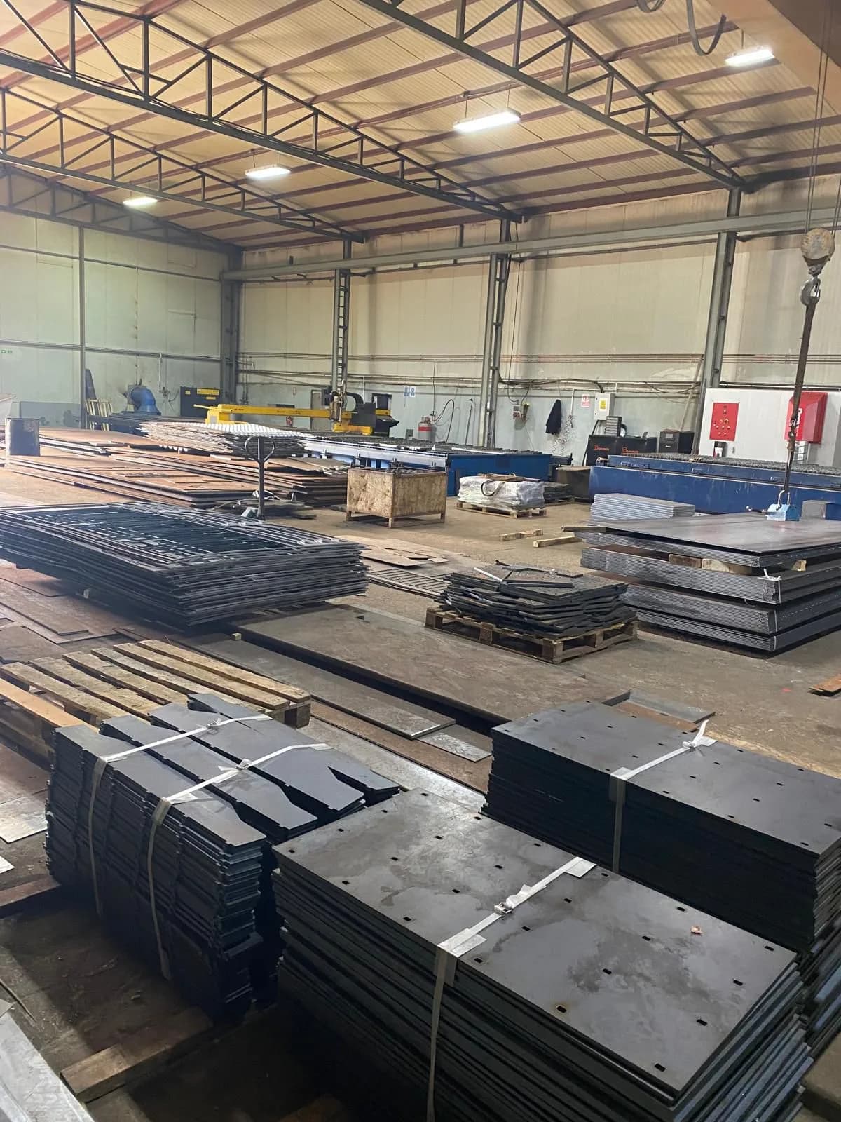 Sheet stock, packed cut parts and the plasma cutting line in the Beta Metal workshop